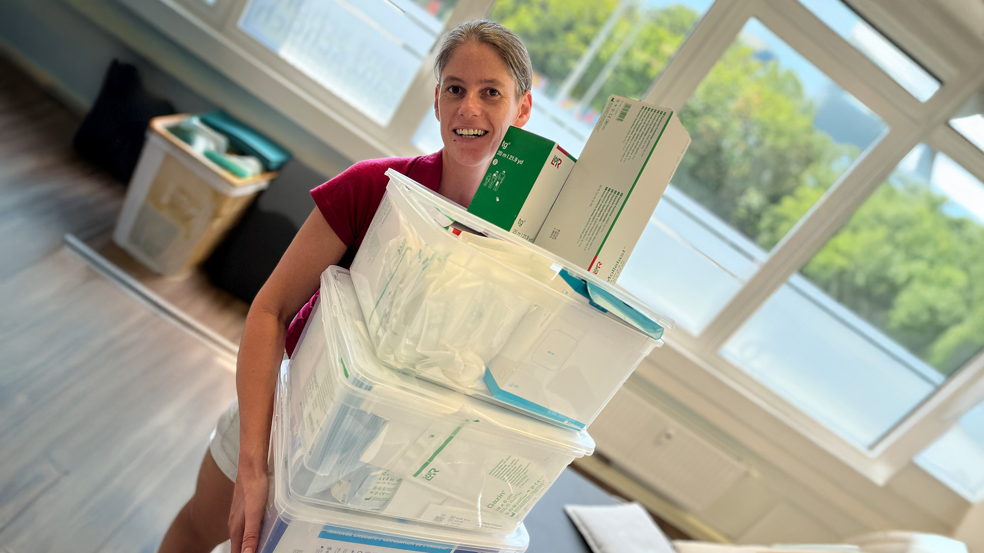 Krankenschwester Alexandra Lafer, zuständig für Wundmanagement, hält einige Boxen mit Verbandsmaterial in den Händen.